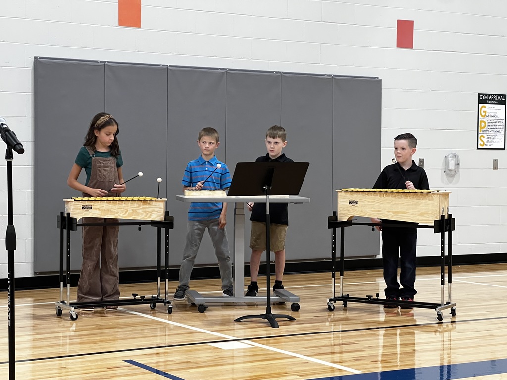 Four 3rd grade students play the instruments together.