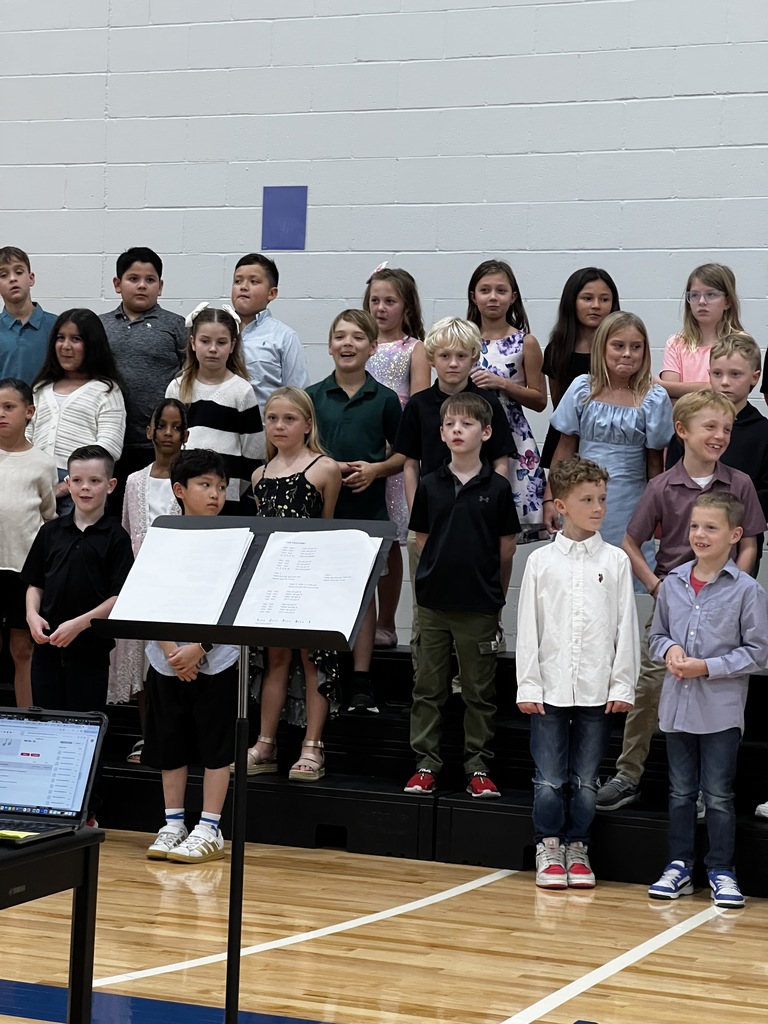 3rd grade students stand on the raisers during their program.
