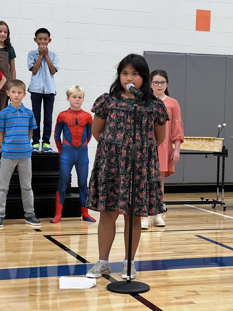 A 3rd grade student performs a solo during the program.