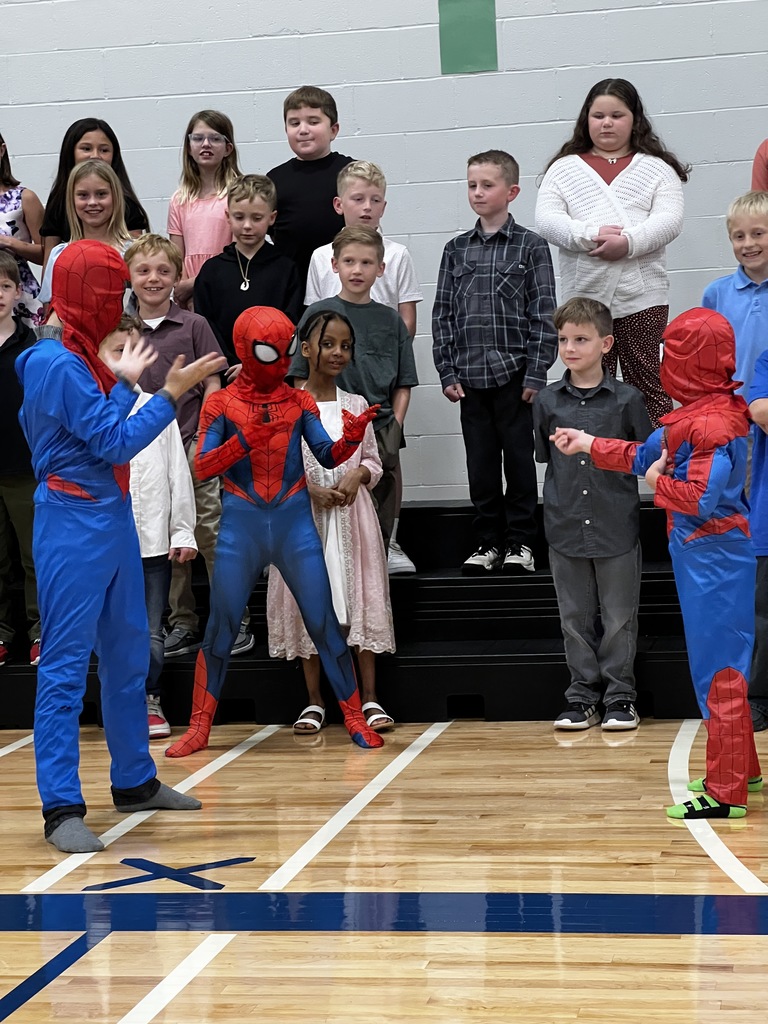 Three 3rd grade students dressed as Spiderman for their performance. 