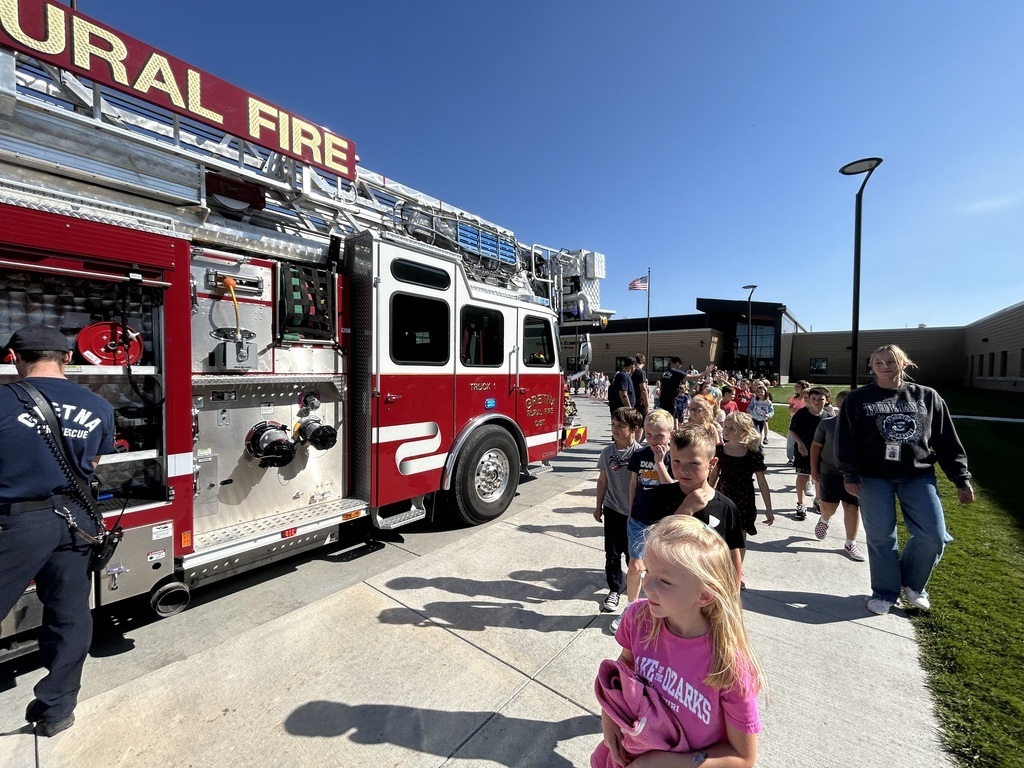 students walking by a fire truck