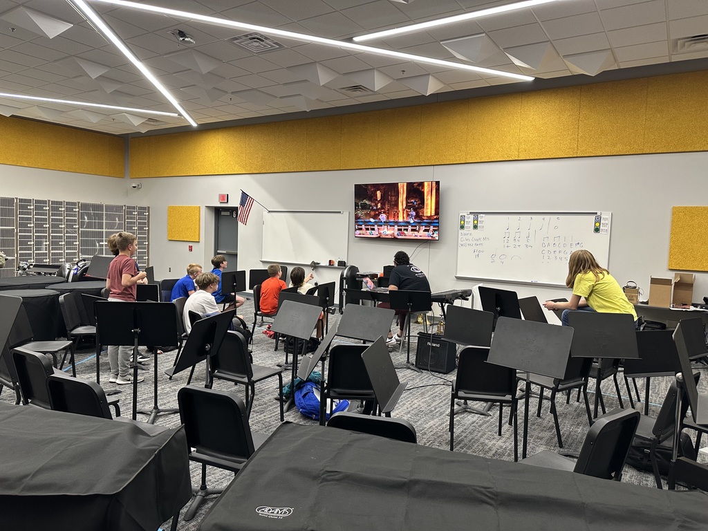 Students and a teacher playing an eSport game on a TV. 