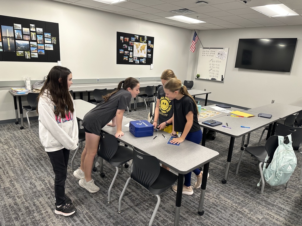 Students working on a breakout box clue. 