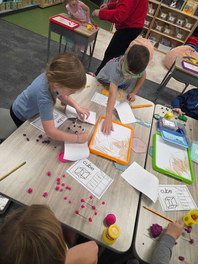 kindergartener working with playdoh and toothpicks