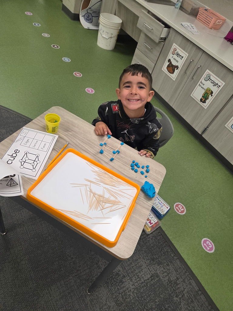 kindergartener working with playdoh and toothpicks