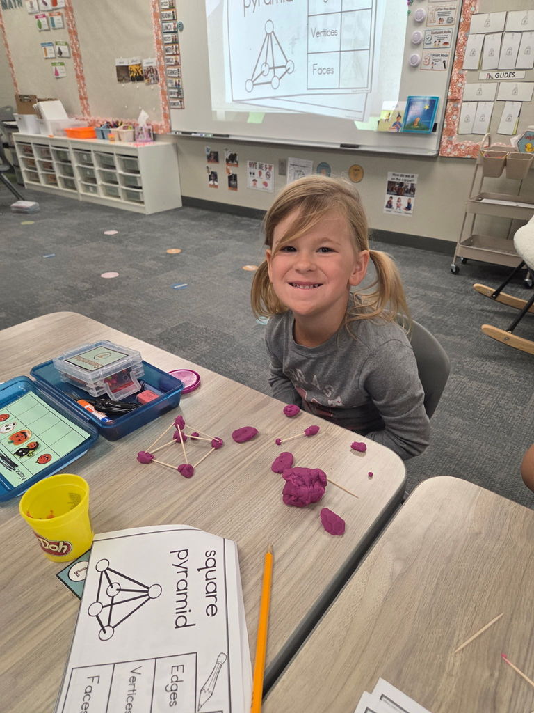 kindergartener working with playdoh and toothpicks