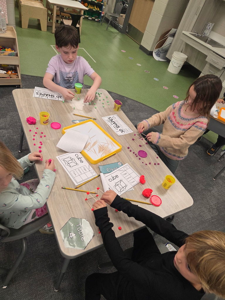 kindergartener working with playdoh and toothpicks