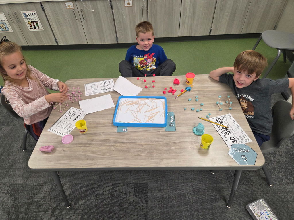 kindergartener working with playdoh and toothpicks