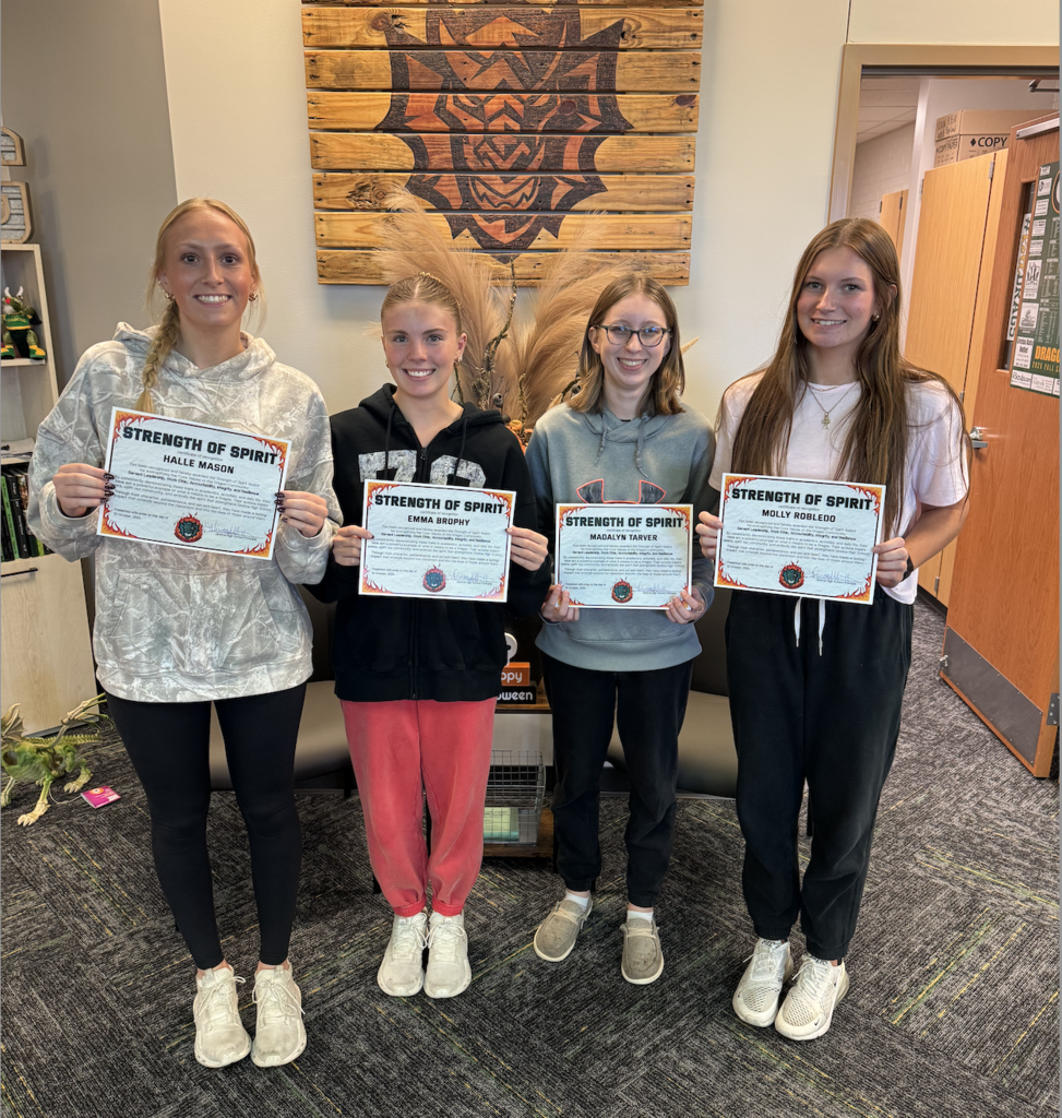 Halle Mason, Emma Brophy, Madalyn Tarver, and Molly Robledo hold their Strength of Spirit certificates.
