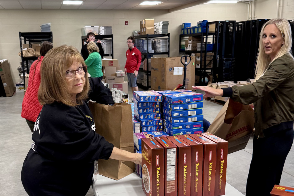 Gretna Backpack Program filling bags of food for community members in need with the young adult program