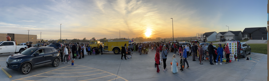photo from the harvest hills trunk or treat. Students in costumes in the parking lot.