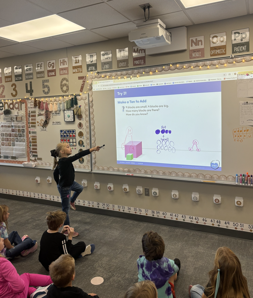 students doing math on the board