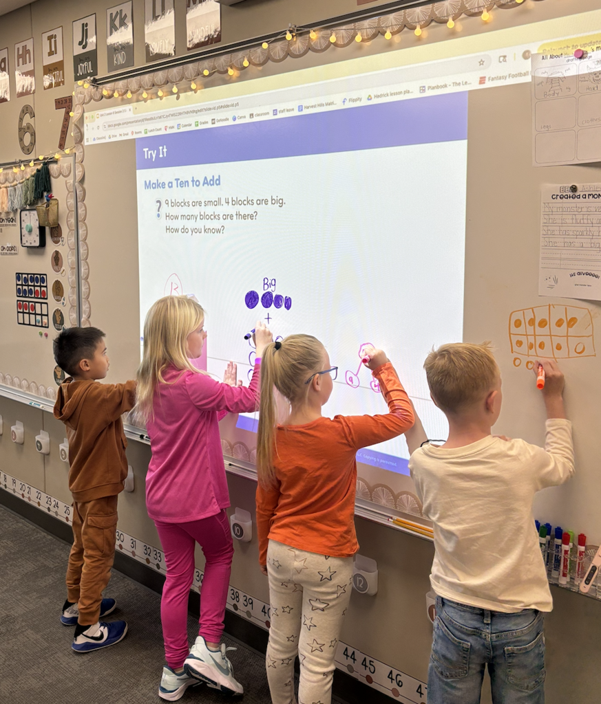 students doing math on the board