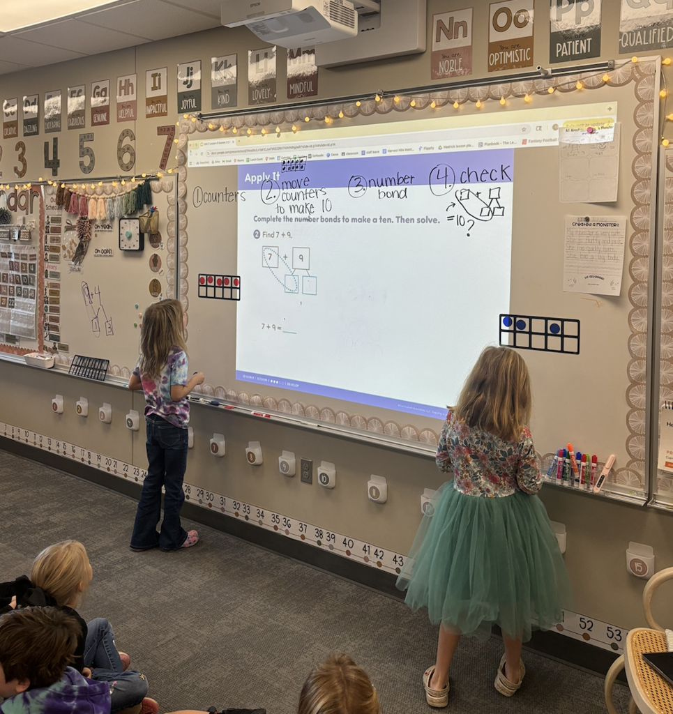 students doing math on the board