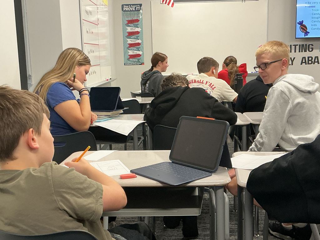 Students in an English classroom are working at their desks. 
