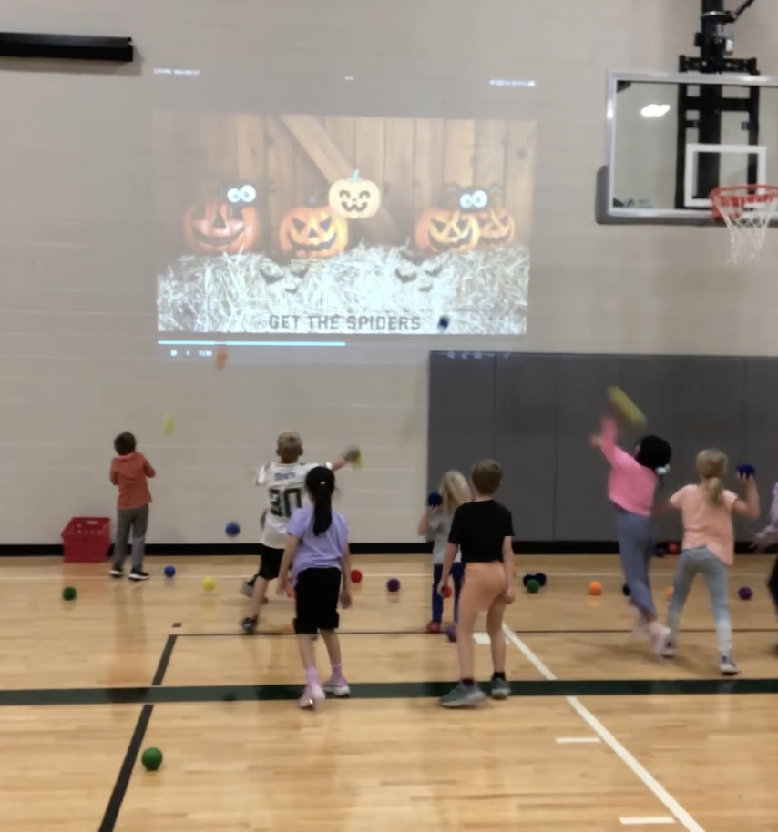 students throwing at a screen in PE class