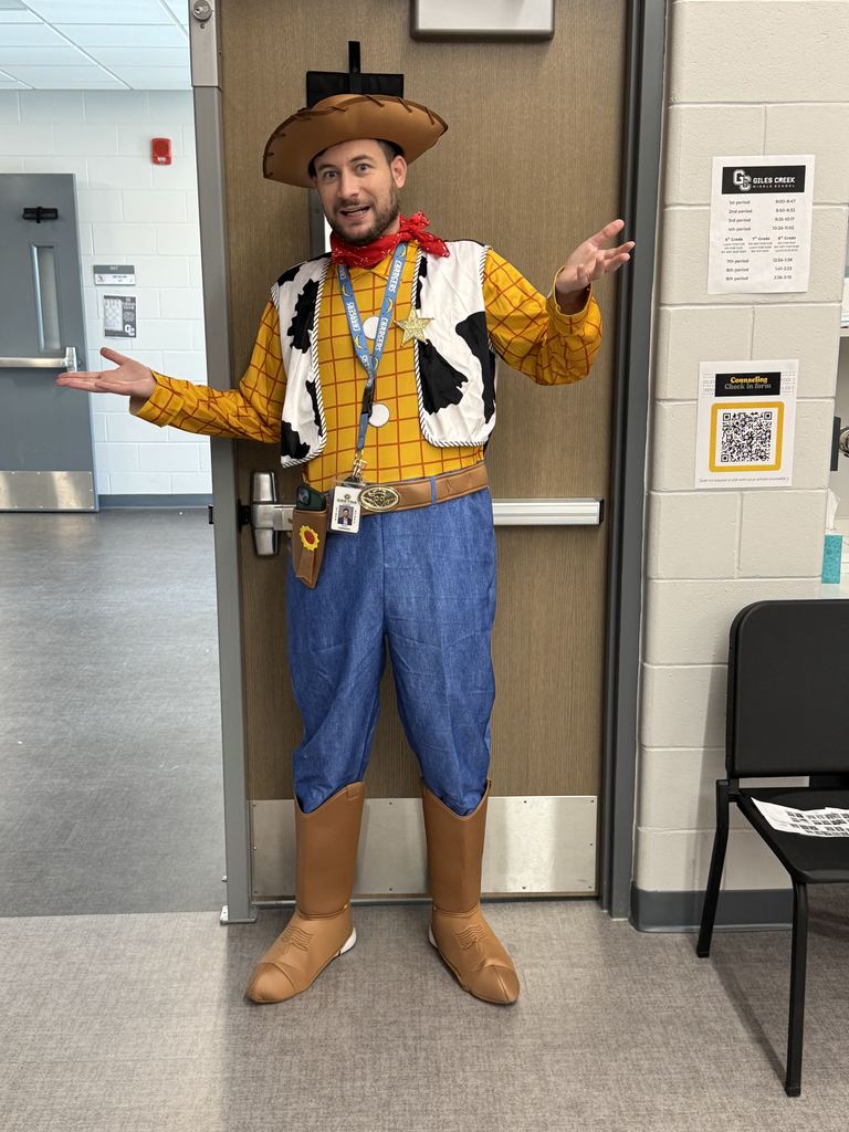 An adult man is dressed up as Woody from the Toy Story movie.  He is shrugging his shoulders with his hands out in the air. 