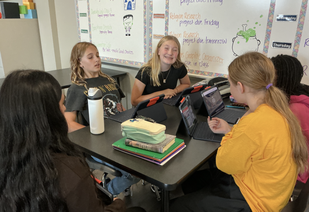 Photo of students working on escape room on their iPads.