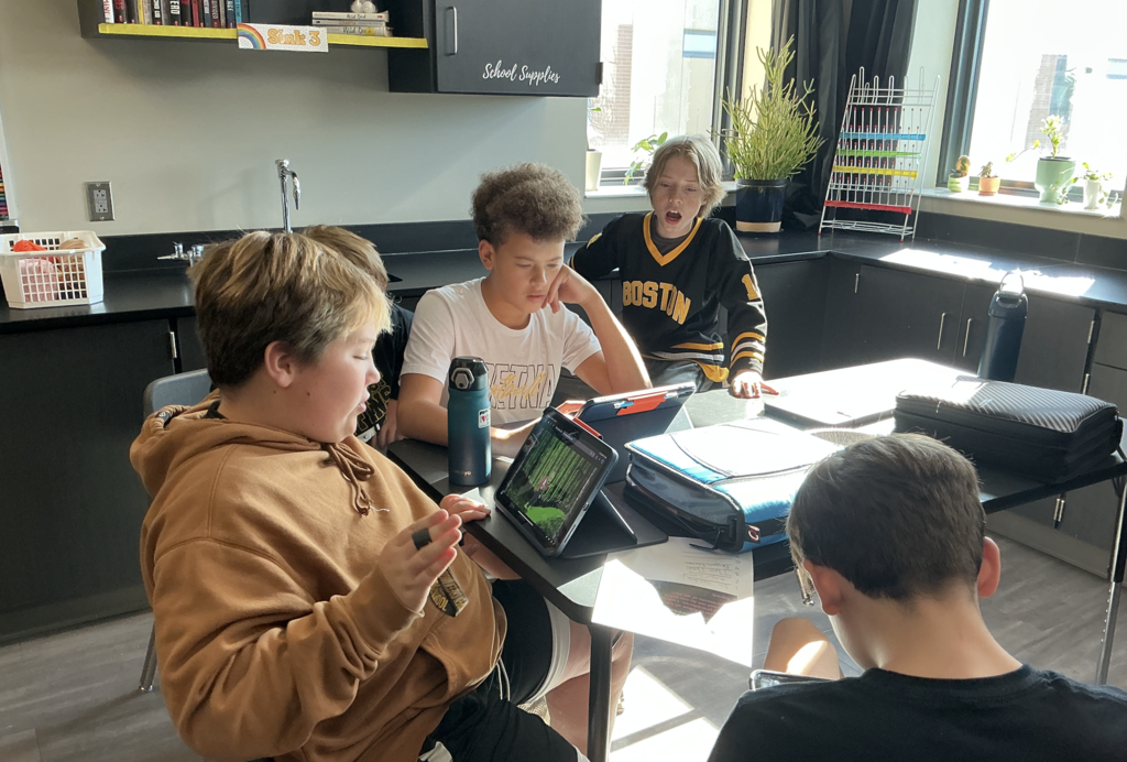 Photo of students working on escape room on their iPads.