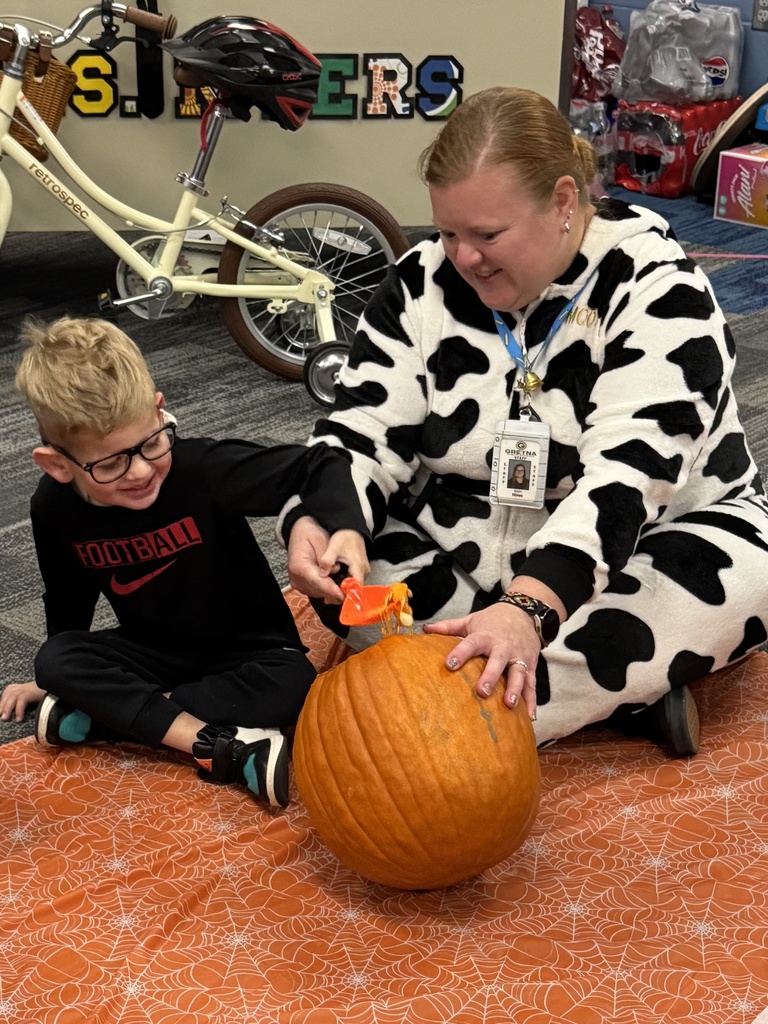 A student and para clean out the pumpkin guts.