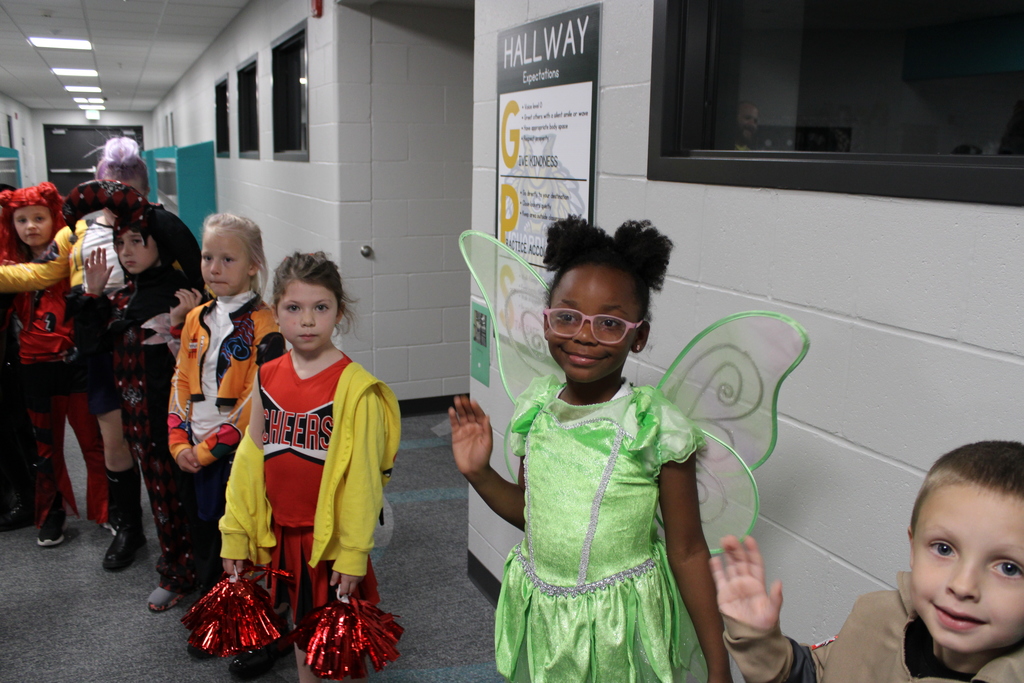 Second grade students watch and wave as the parade goes by.