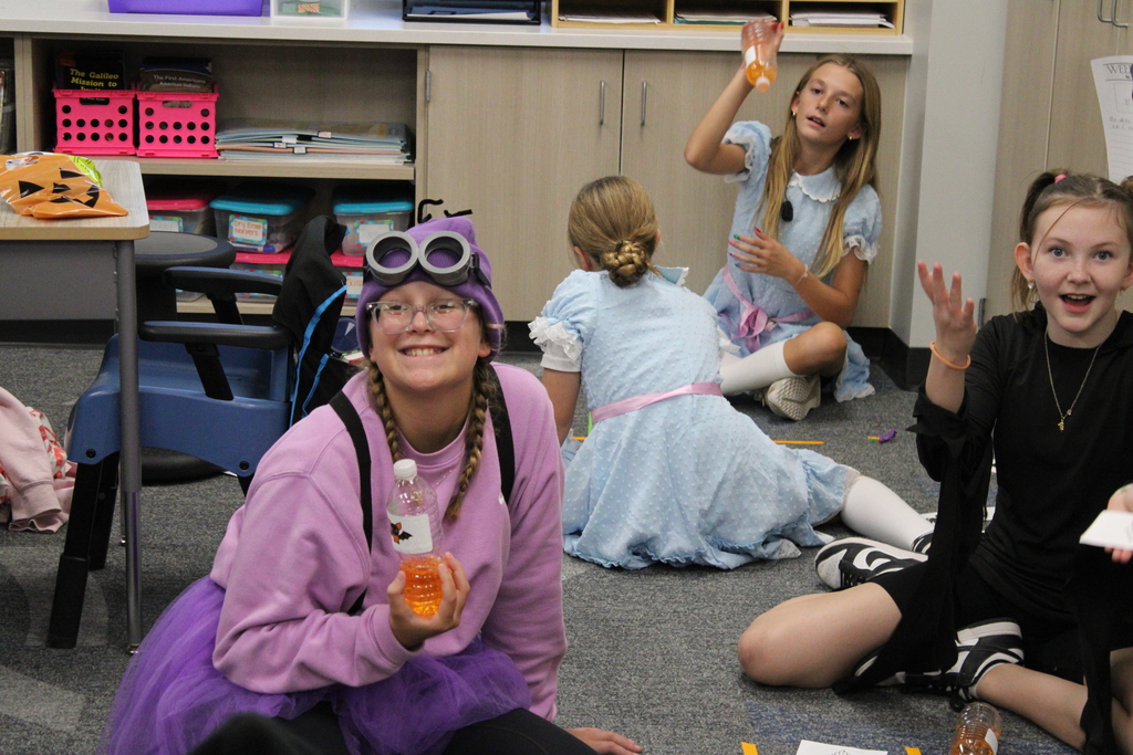 Fifth graders flip bottles as a game during their party. 