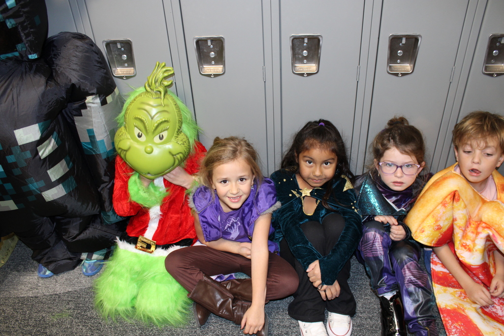 First grade students wait along the lockers for the parade to begin. 