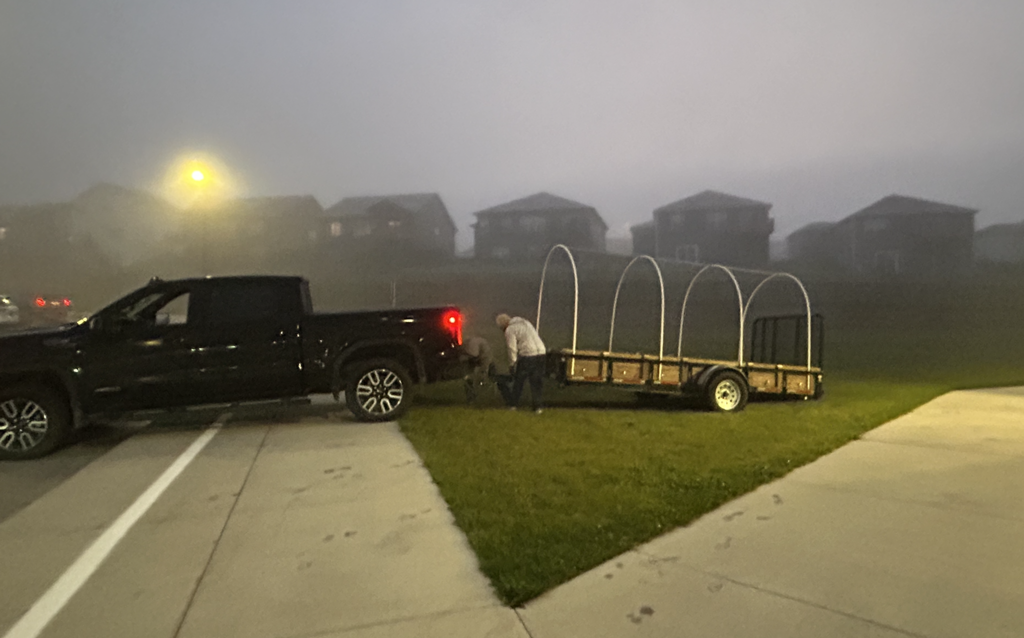 a covered wagon being dropped off at school