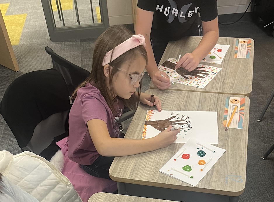 student working on autumn artwork