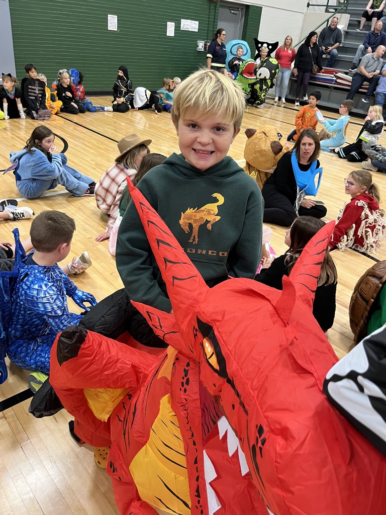 Student wearing a red dragon inflatable costume.