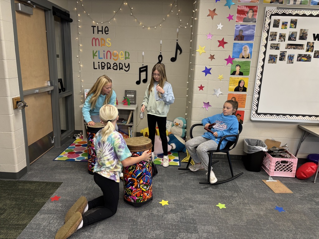 fifth graders practice drums in music class