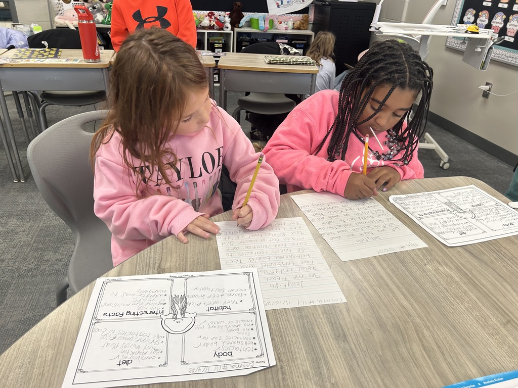 students work on a project at a table in a classroom