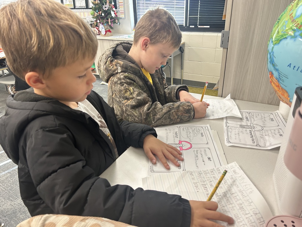 students work on a project at a table in a classroom