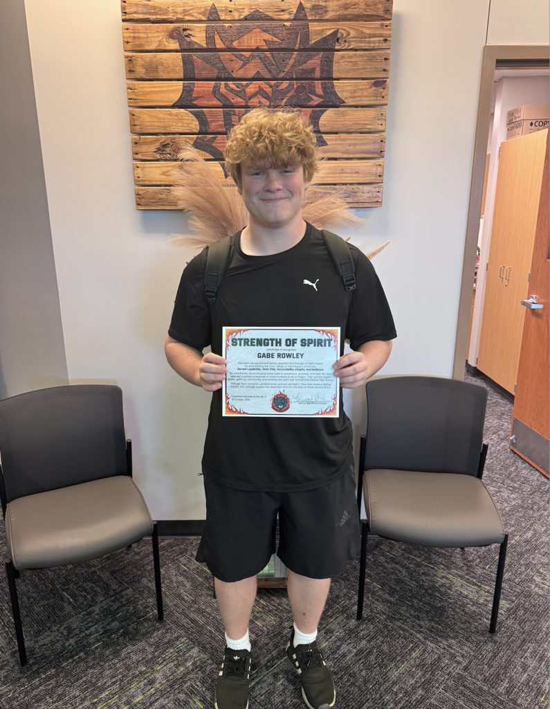 Gabe Rowley holds his strength of spirit certificate