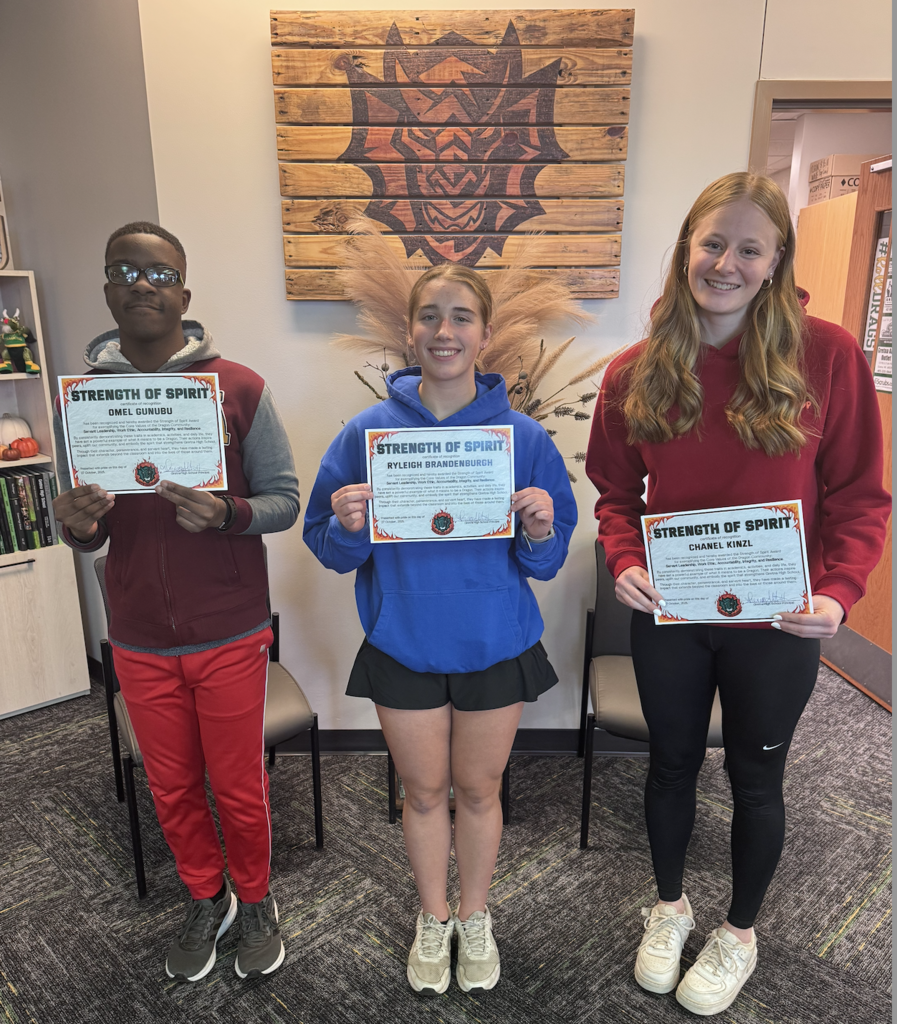 Omel Gunubu, Ryleigh Brandenburgh, and Chanel Kinzl hold their Strength of Spirit Certificates