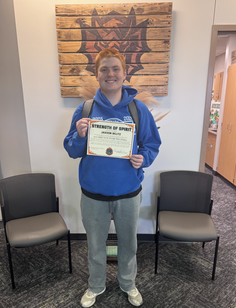 Jaxson Belitz holds his Strength of Spirit certificate