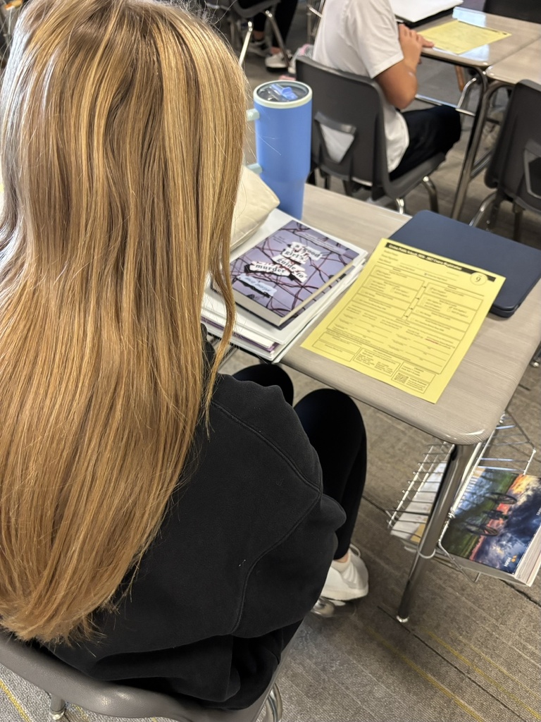 Photo of the back of a student who is looking at her registration sheet.