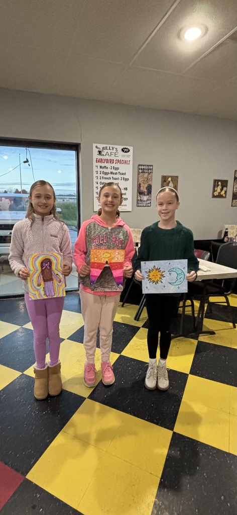 three students holding their artwork to for the Optimist Club to view