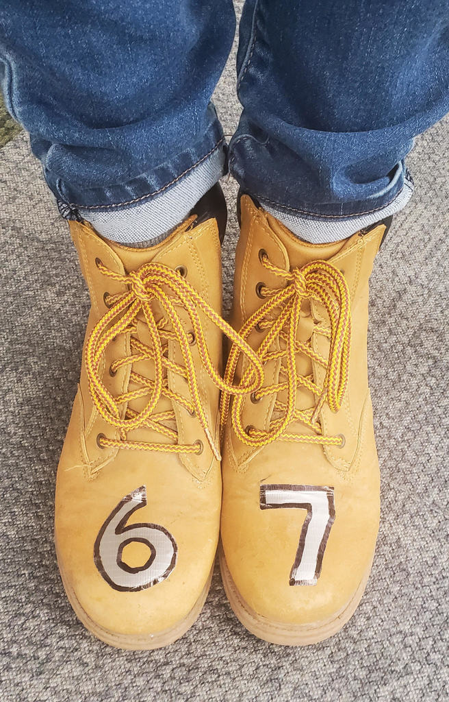 shoes with the number 6-7 taped on them