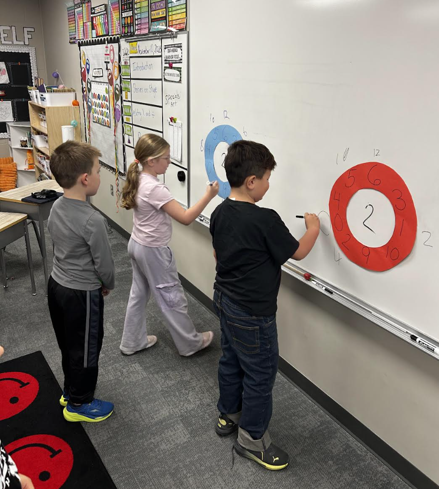 students doing math on the board