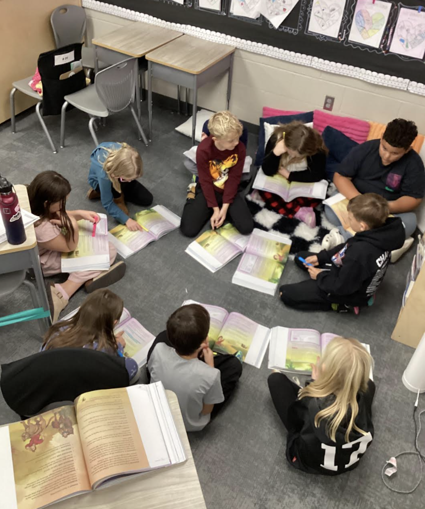 students reading from their books