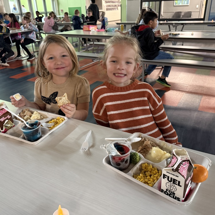 2 kindergartners enjoy their Thanksgiving feast