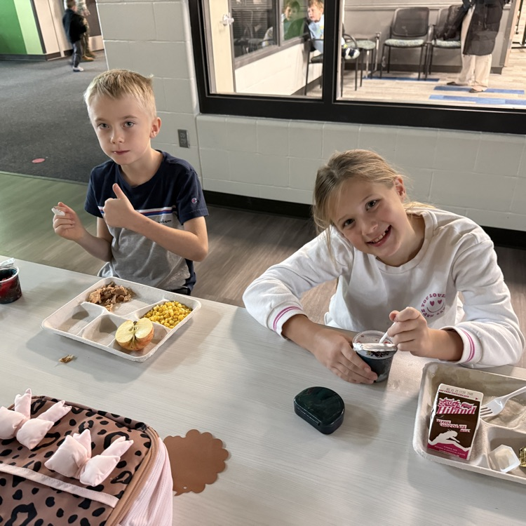 2 4th graders enjoy their Thanksgiving feast