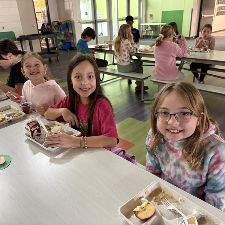 3 4th graders enjoy their Thanksgiving feast