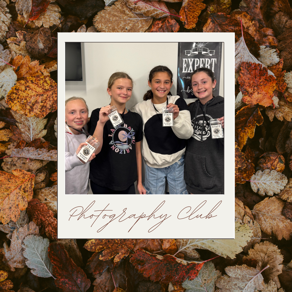 Background photo of fall leaves. On top of that is a polaroid-style frame with a photo of four photography club students inside of it. Students in the picture are holding up their photography club staff badges. Below the image is text stating: Photography Club.