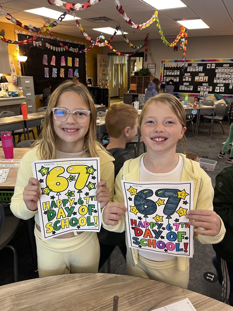 students celebrating coloring work on the 67th day of school