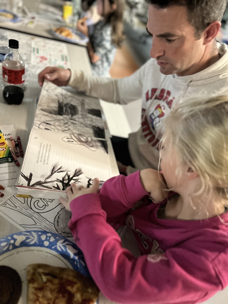 father and daughter reading a story
