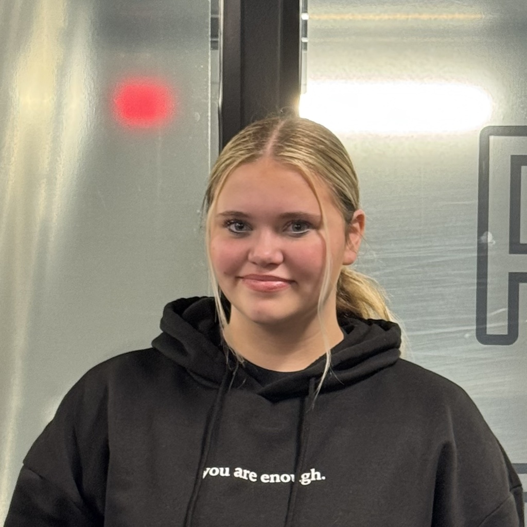 Photo of 8th grade student, Emma Sanfilippo, who was selected for honor choir. The photo shows her from the shoulders up with her hair in a ponytail.