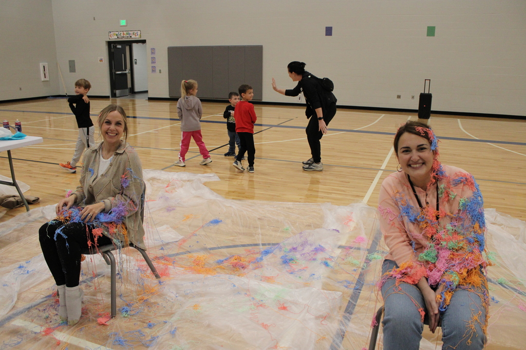 The kindergarten teachers pose for a smile after getting sprayed with silly string by their students. 