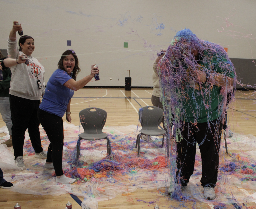 The teachers turn on Mr. Runyon as they spray him with silly string!